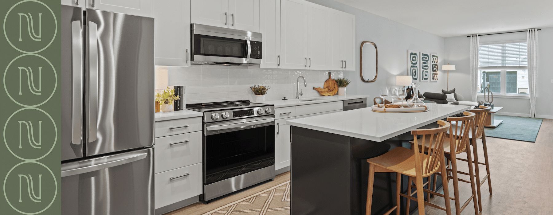 Kitchen in an apartment for rent featuring a row of white cabinets, and stainless steel appliances