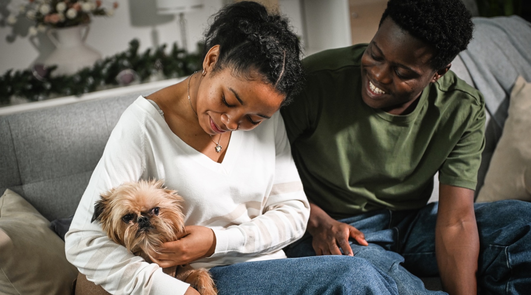 two people holding their pet